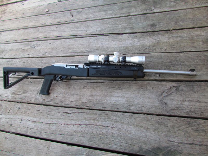 The fully assembled Ruger Takedown 10/22 in scout configuration with folding stock extended.